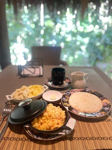 a table with plates of food on a table at Magdalena Beach House in Los Naranjos