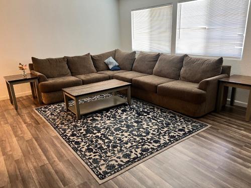a living room with a brown couch and a rug at Lovely 1bed,1bath condo with free parking in Fresno