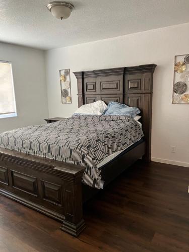 a bedroom with a large bed with a wooden headboard at Lovely 1bed,1bath condo with free parking in Fresno
