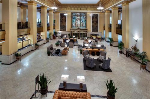 a lobby with couches and tables in a building at Drury Plaza Hotel San Antonio Riverwalk in San Antonio