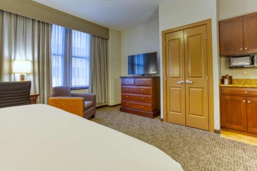 a hotel room with a bed and a flat screen tv at Drury Plaza Hotel San Antonio Riverwalk in San Antonio