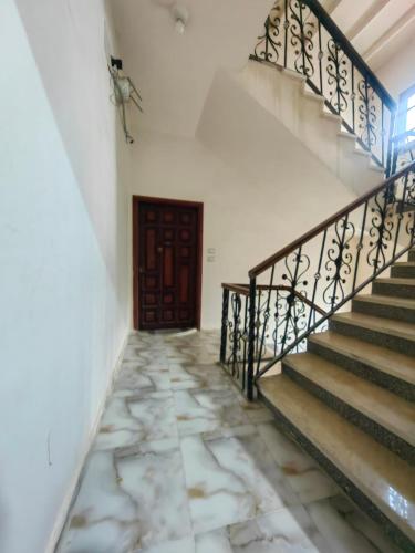 an empty hallway with stairs and a door at kelany home in Siwa