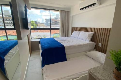 Una cama o camas en una habitación de Flat beira-mar em Porto de Galinhas