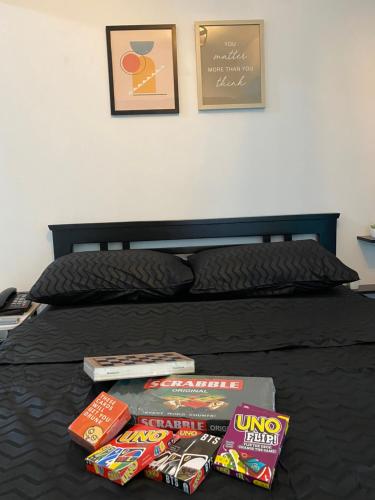 a bed with two pizzas and snacks on it at LizJen Staycation at Azure Urban Resort in Manila
