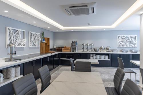 a kitchen with blue cabinets and a counter with chairs at Hotel Biltmore in Guatemala