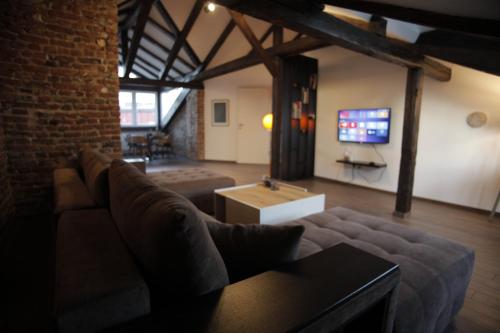 a living room with a couch and a tv at Charming boutique apartment in Skopje in Skopje