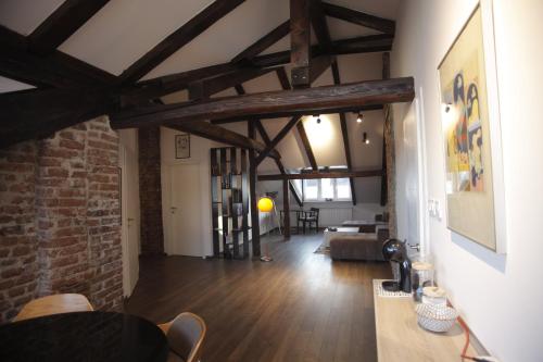 a living room with wooden floors and a brick wall at Charming boutique apartment in Skopje in Skopje