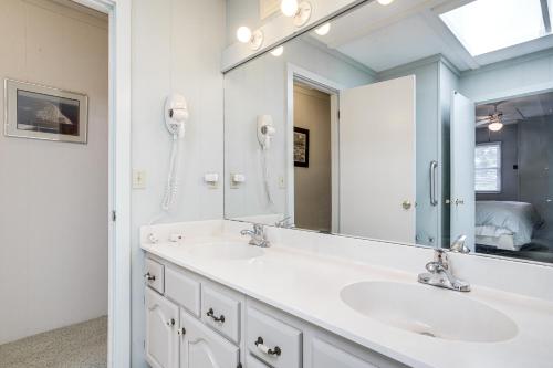 a bathroom with two sinks and a large mirror at 2 Mi to Beach Gem with Enclosed Patio in Selbyville in Selbyville
