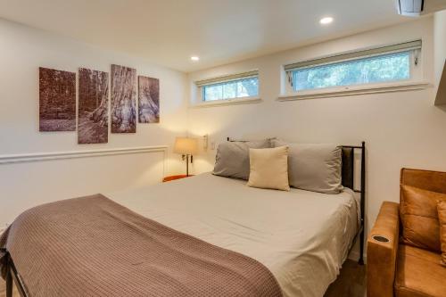 a bedroom with a bed and two windows at Updated Three Rivers Vacation Rental with Gas Grill in Three Rivers