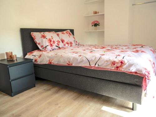 a bedroom with a bed with a dresser and a bed sidx sidx at Landhuis Brakelbos in Sint-Maria-Oudenhove