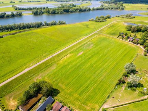 an aerial view of a field and a river at Het Grootenhuis in Olst