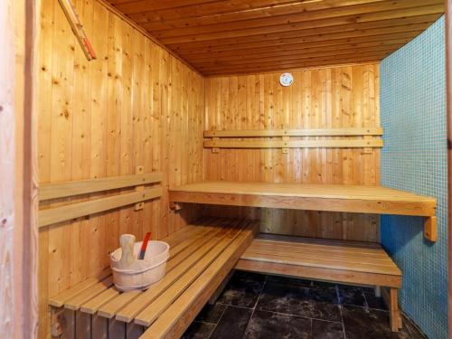 a wooden sauna with wooden shelves and a bucket at Het Grootenhuis in Olst