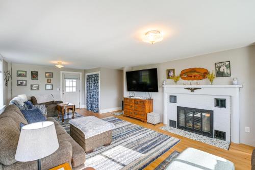 a living room with a couch and a fireplace at Cherryfield Home with Decks On Historic Horse Farm in Milbridge