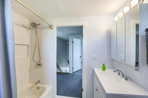 a white bathroom with two sinks and a shower at Cherryfield Home with Decks On Historic Horse Farm in Milbridge