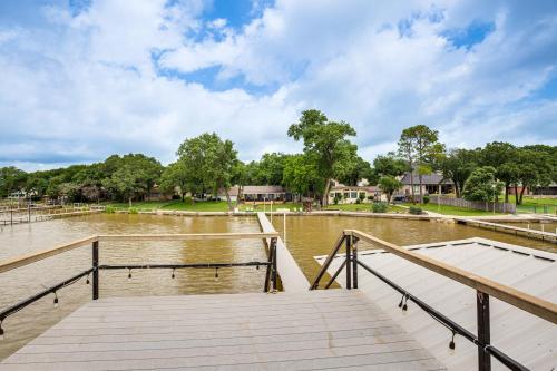 a dock on a body of water with houses at Private Dock and Deck Eagle Mountain Lake Retreat! in Rhome
