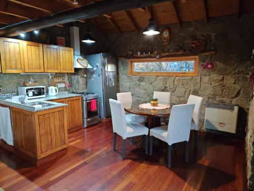a kitchen with a table and chairs in a room at Green House in El Calafate
