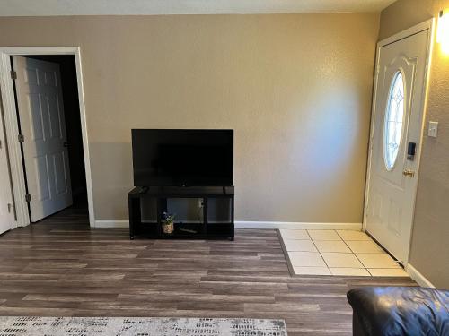 a living room with a flat screen tv on a wall at Quiet 1bed,1bath condo with free parking in Fresno