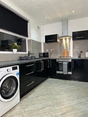 a kitchen with a washer and a washing machine at Marvellous & Stylish Place in Middlesbrough