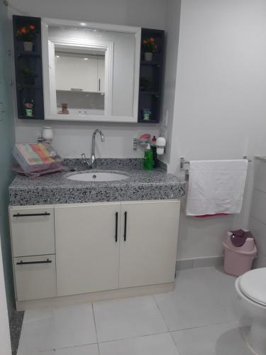 a white bathroom with a sink and a toilet at Scandic beach resort in Hurghada