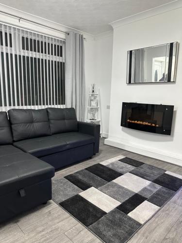 a living room with a couch and a fireplace at Marvellous & Stylish Place in Middlesbrough