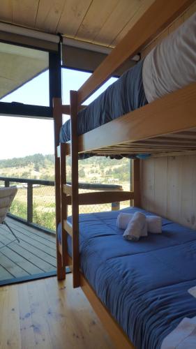 two bunk beds in a room with a balcony at Casalmar Pupuya in Pupuya