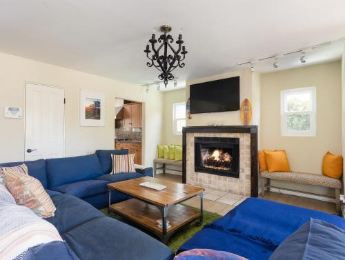 a living room with a blue couch and a fireplace at El Segundo Beach 5B4b Home, POOL Hot Tub, BEACHES, Local Town! in El Segundo