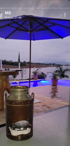 a can sitting on a table with an umbrella at RANCHO PARAISO PARAISO do ZIRINHO in Guapé