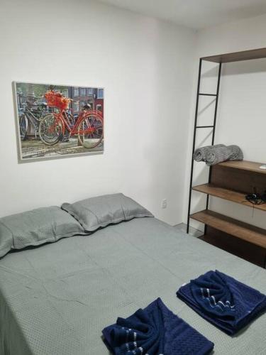 a bedroom with a bed with blue towels on it at Apto próximo ao Pátio do Forró in Caruaru