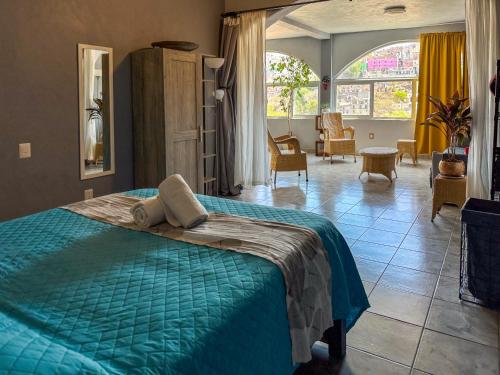 Casa de Colores في غواناخواتو: غرفة نوم مع سرير وغرفة معيشة