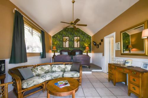 a living room with a couch and a table at Sea Breeze Manor Inn in St Petersburg