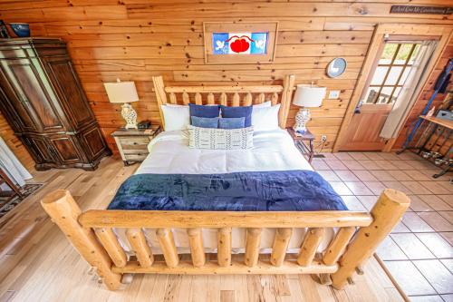 1 dormitorio con 1 cama en una cabaña de madera en Love Me Tender Studio Cabin en Sevierville