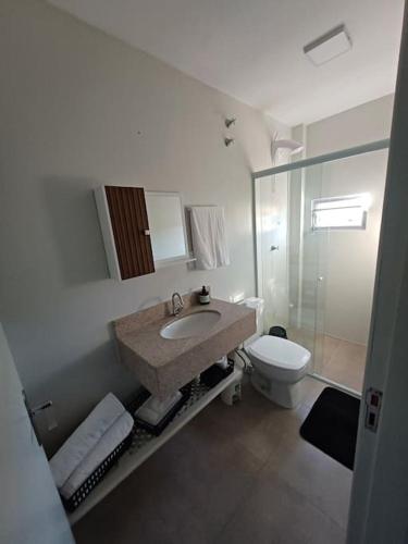 a bathroom with a sink and a toilet at Apartamento Termas do Gravatal in Gravatal