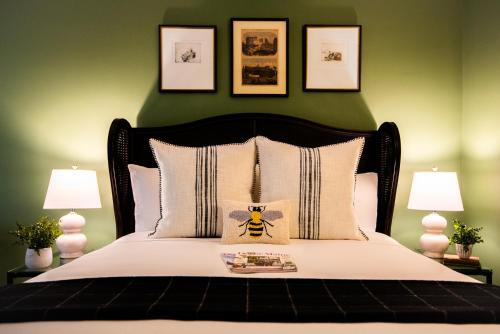 a bedroom with a bed with a bee on the pillow at Cleftstone Inn in Bar Harbor