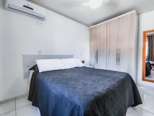 a bedroom with a large bed in a white room at Hospedagem Stein · Lindo Apto 2 quartos em Domingos Martins in Domingos Martins