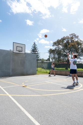two people playing basketball on a basketball court at Tasman Holiday Parks - Albany in Albany