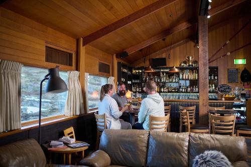a group of people standing at a bar at Barrakee Ski Lodge in Perisher Valley