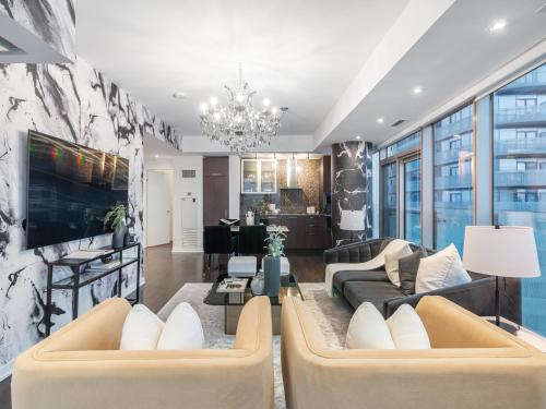 a living room with a couch and a table at Luxury 2Br Condo Entertainment District Downtown CN Tower View Balcony Pool & Hot Tub in Toronto