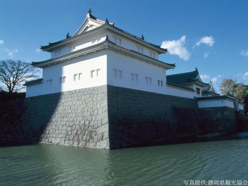 a building on a brick wall in the water at Hotel Wing International Shizuoka in Shizuoka