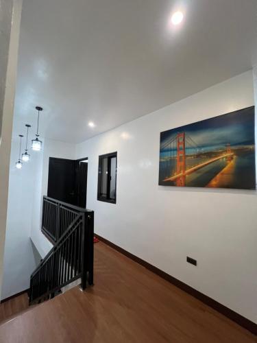 a stairway with a painting of a bridge on a wall at RM VILLALON Residence in Manila