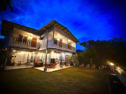 a large house with a yard at night at Blasina Beer Hostel in Boquete