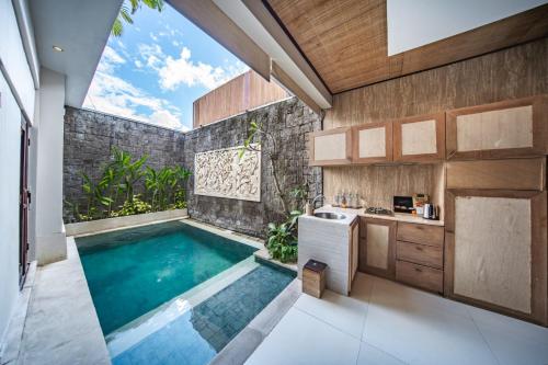 a swimming pool in the kitchen of a house at Ini Vie Villa Legian by Ini Vie Hospitality in Legian