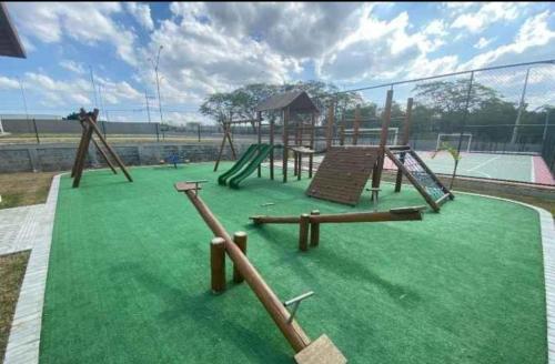 a playground with a slide and a swing at Studio Garden 03 in Caruaru
