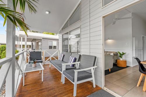 a porch with two chairs and a table at BIG4 Tasman Holiday Parks - Tathra Beach in Tathra