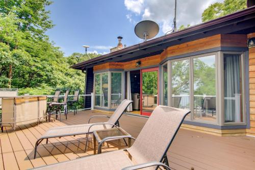 a deck with chairs and tables on a house at Walk to Tuttle Creek Lake Secluded Scenic Retreat in Manhattan
