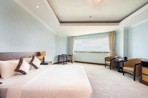 a hotel room with a bed and a window at PHU MY HARBOUR HOTEL - Old Golf Phu My Hotel in Phú Mỹ