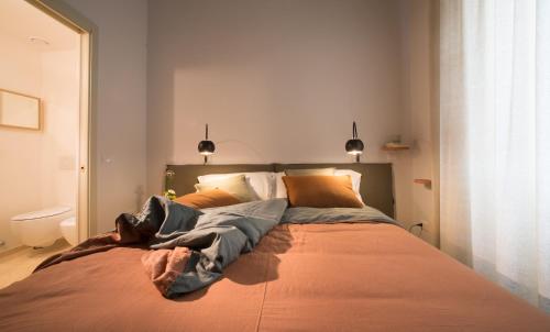 a bedroom with a large bed with orange sheets at B&B Santa Maria del Fiore in Florence