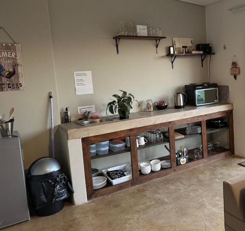 a kitchen with a counter with dishes and a microwave at Breathtaking Midlands stay at THE PROTEA CHALET 5kms from N3 in Hilton