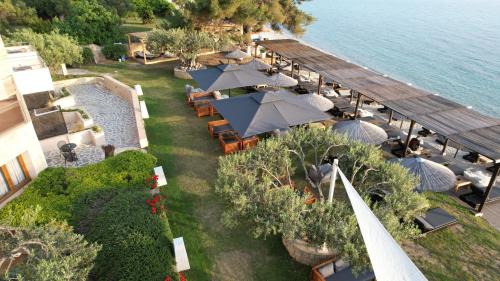 an overhead view of a restaurant with tables and umbrellas at Olympion Sunset Halkidiki in Fourka