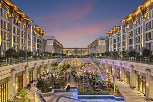 a view of a courtyard of a building with people at Shinhwa Jeju Shinhwa World Hotels in Seogwipo