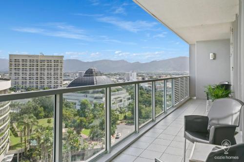 an apartment balcony with a view of the city at 1101 Harbour Lights with Ocean Views in Cairns